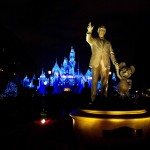 Disneyland_Holiday lights on Sleeping Beauty Castle disneyland castle at night with walt and mickey in the foreground