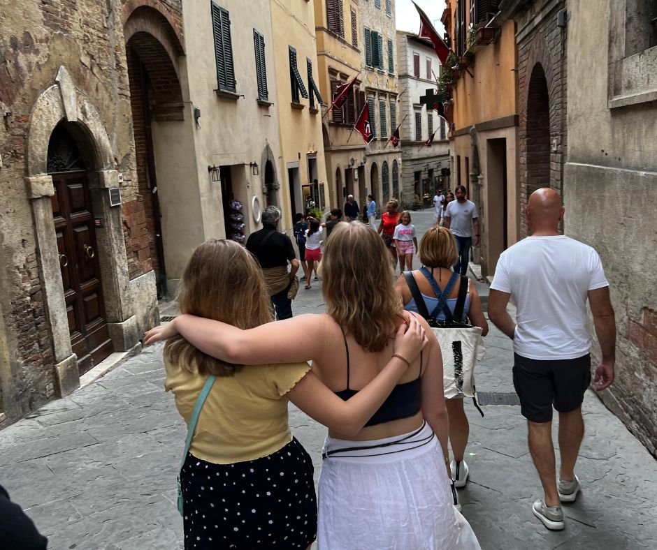 family walking streets in tuscany